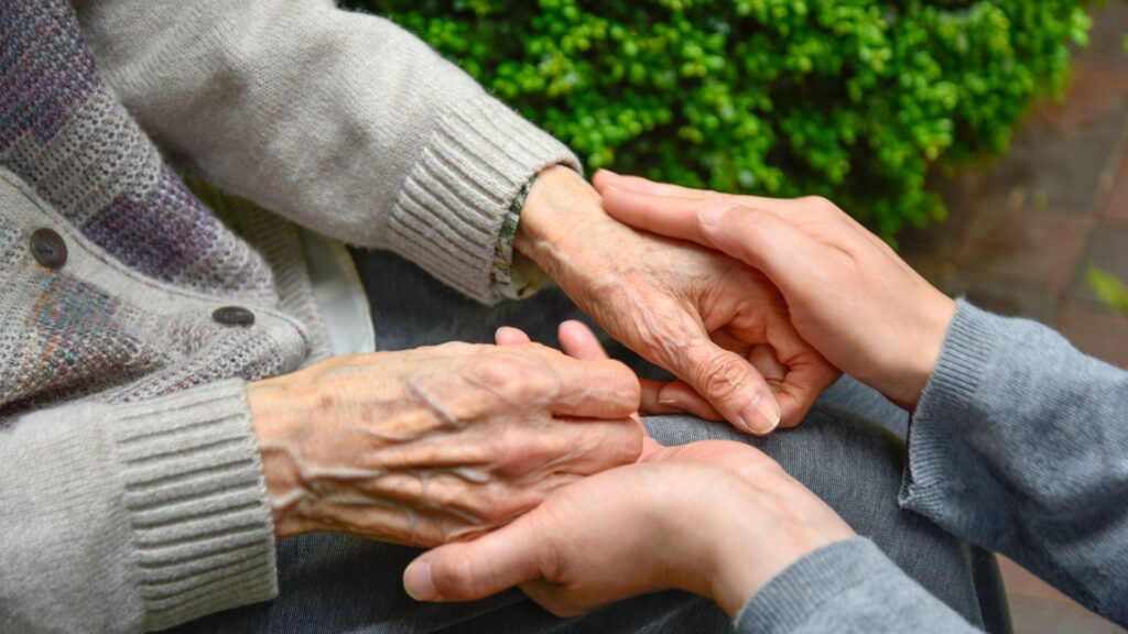 day care carer cupping client's hands