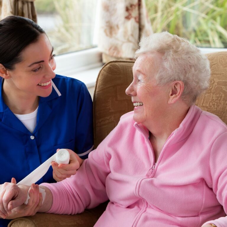 reablement care- carer bandaging elderly lady's arm