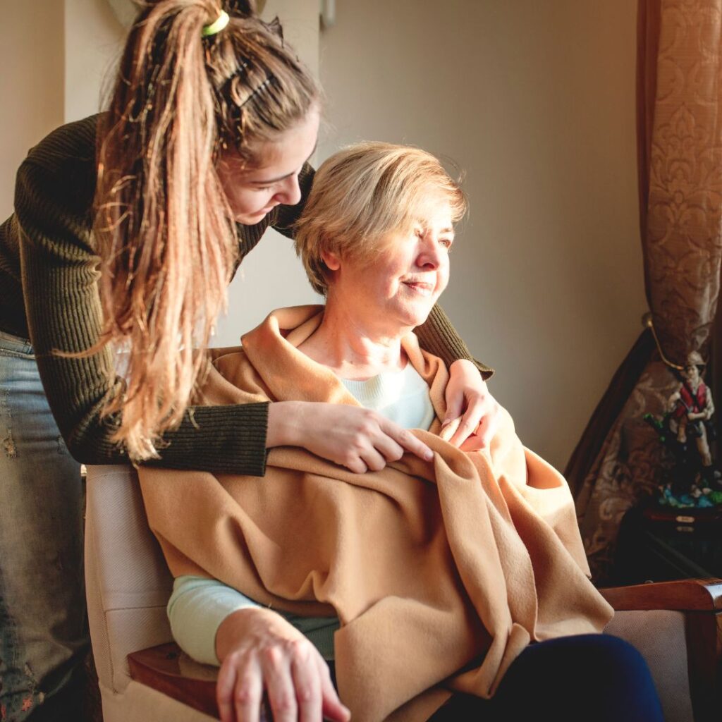 woman receiveing palliative care from carer